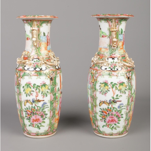 9 - A pair of 19th century Chinese Cantonese famille rose vases. Height 26cm.