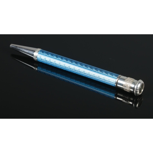 90 - A silver and blue enamel retractable ball point pen with engine turned barrel. Assayed London 2000 b... 