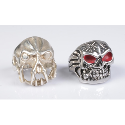 466 - Two skull rings; one stamped S925, the other white metal with red eyes. Sizes T & Y.