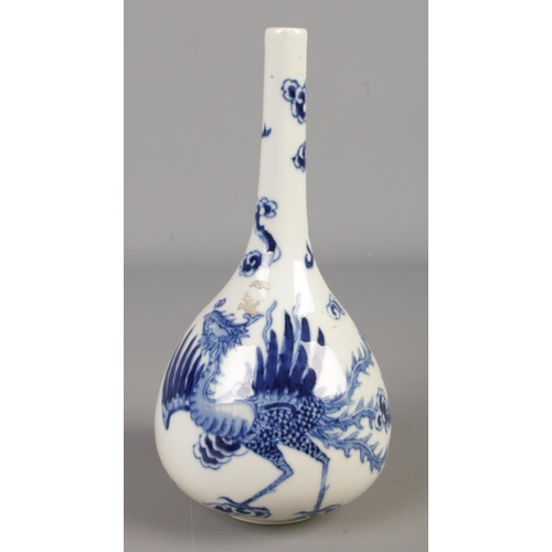 170 - A Chinese blue and white bottle vase. Decorated with a Phoenix amongst clouds. Height 22.5cm.