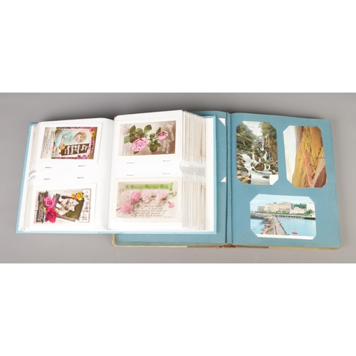 203 - Two folders containing a large collection of vintage postcards, greetings cards and photographs. The... 