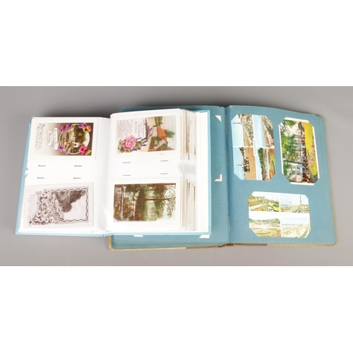 203 - Two folders containing a large collection of vintage postcards, greetings cards and photographs. The... 