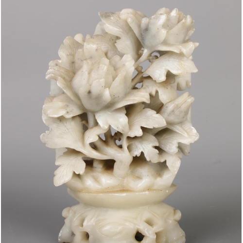 213 - A collection of seven Chinese soapstone ornaments, intricately hand carved with floral designs and a... 