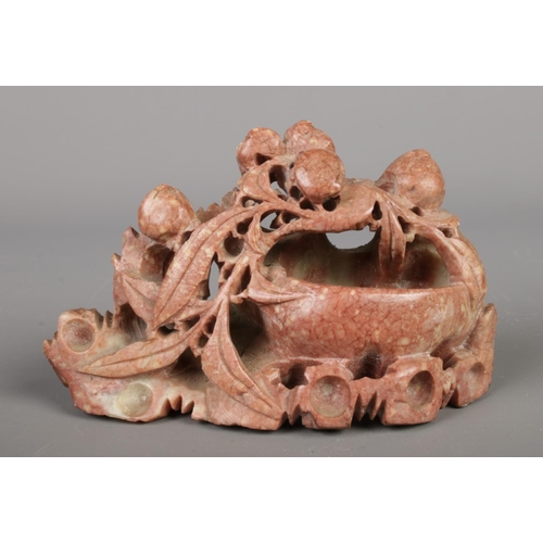 213 - A collection of seven Chinese soapstone ornaments, intricately hand carved with floral designs and a... 