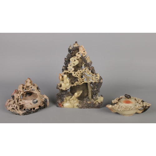 217 - A set of three matching Chinese soapstone pieces in cream and black tones, comprising a sculpture de... 