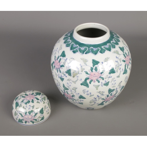 219 - A large 20th century Chinese porcelain ginger jar with lid, finely decorated with pink lotus blossom... 