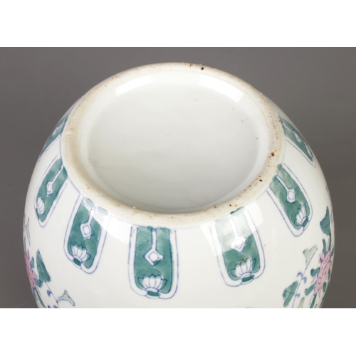 219 - A large 20th century Chinese porcelain ginger jar with lid, finely decorated with pink lotus blossom... 