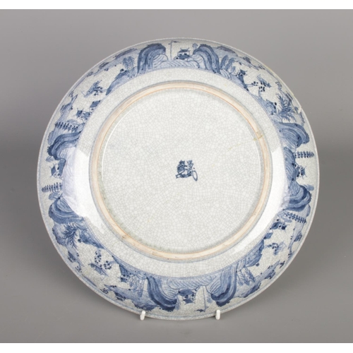 222 - A large early 20th century Chinese blue and white charger decorated with birds and flowers scenes.