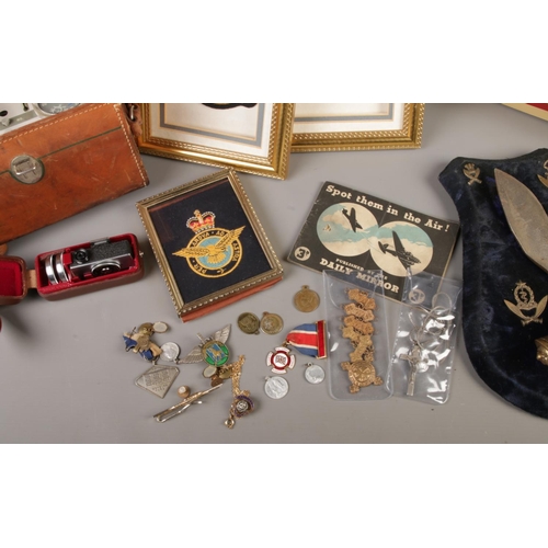 232 - A mixed quantity of collectables including framed RAF patches, shield display with mounted pair of m... 