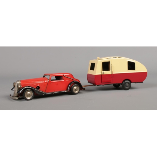 239 - A Tri-ang tin plate Vauxhall cabriolet in red with black sides, together with boxed Tri-ang caravan.