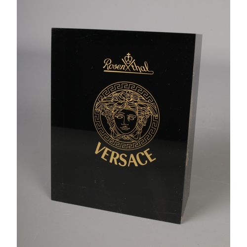 251 - A Versace resin shop display plaque.