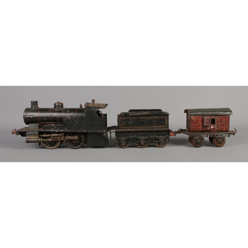 266 - A vintage Gebruder Bing 0-4-0 O Gauge steam engine and tender.