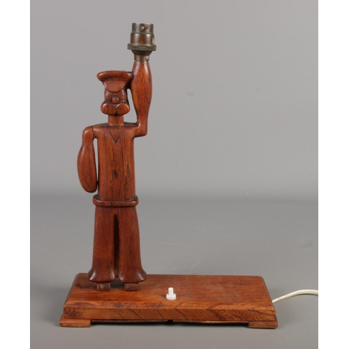 288 - A carved oak figural table lamp. Bearing plaque to base - Carved by LBR C Longley, May 1945, Isle of... 