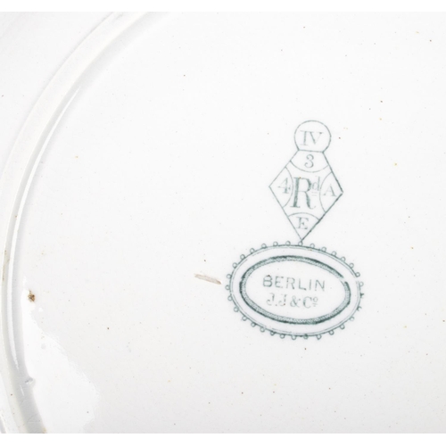 298 - A collection of antique J Jackson J.J & Co Berlin plates including two large platters.