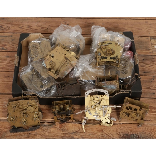 304 - A box of assorted mantle clock movements with examples including Empire, Garrard and Smiths