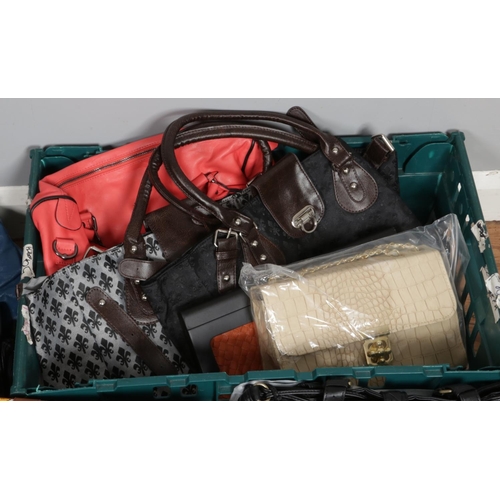 325 - A box of fourteen ladies hand bags in various size, colour and styles, all unused some with protecti... 