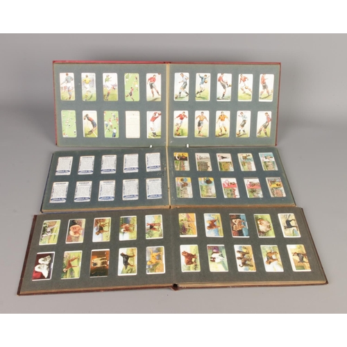 326 - A large collection of assorted cigarette cards, trade cards, silk cigarette cards, albums and a fram... 