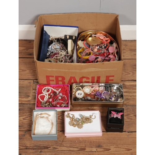 341 - A large box of assorted costume jewellery and accessories. To include wristwatches, necklaces, bangl... 