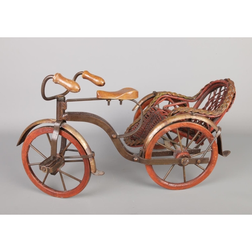 353 - A vintage richshaw pedicab, made with a combination of wicker and metal, wheels and pedals can move.