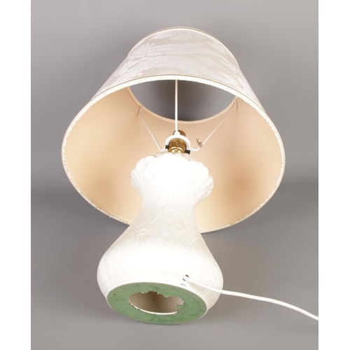 354 - A Belleek porcelain table lamp with cream shade.