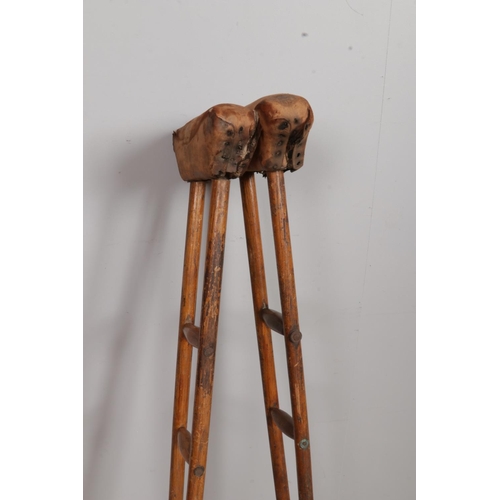 376 - A pair of antique wooden crutches. Possibly of military interest. Length 116cm.