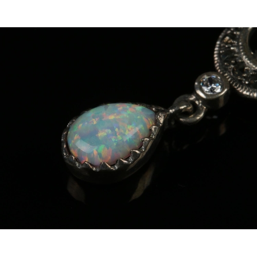 417 - A silver opal necklace with matching opal earrings.