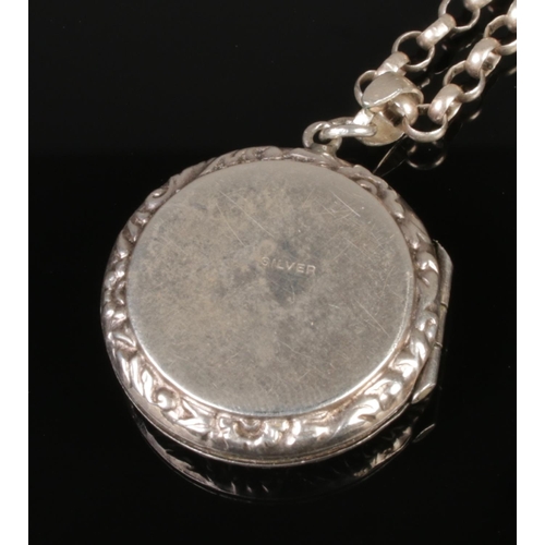 420 - A silver locket necklace featuring a light blue enamel front with a floral guilloche pattern.