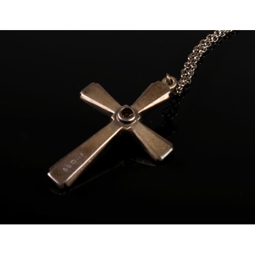 421 - A vintage sterling silver cross pendant with a white metal chain, featuring a Stanhope lens at the c... 