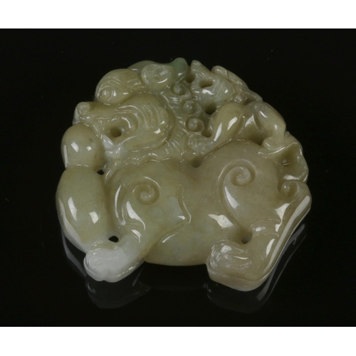 427 - An antique Chinese Jade Lion ornament, featuring a bicolour natural jade carving of temple lion with... 