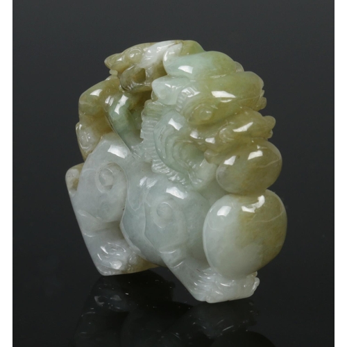 427 - An antique Chinese Jade Lion ornament, featuring a bicolour natural jade carving of temple lion with... 