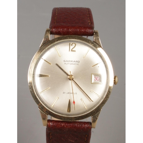 461 - A gents 9ct gold Garrard automatic wristwatch. With centre seconds, baton markers and date display.