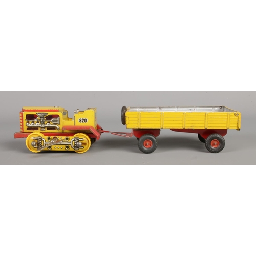 491 - A vintage West German Arnold Raupe tin plate clockwork vehicle, No. 820, with similar tipper trailer... 