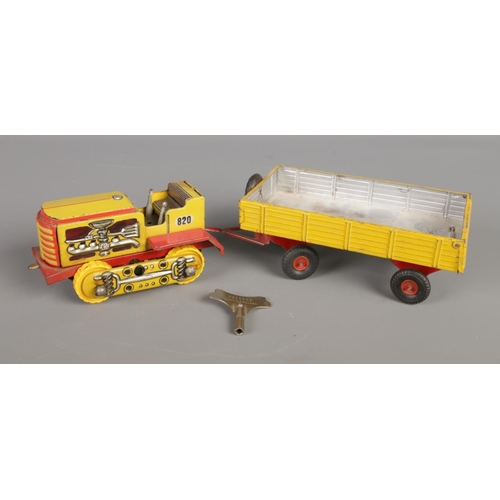 491 - A vintage West German Arnold Raupe tin plate clockwork vehicle, No. 820, with similar tipper trailer... 