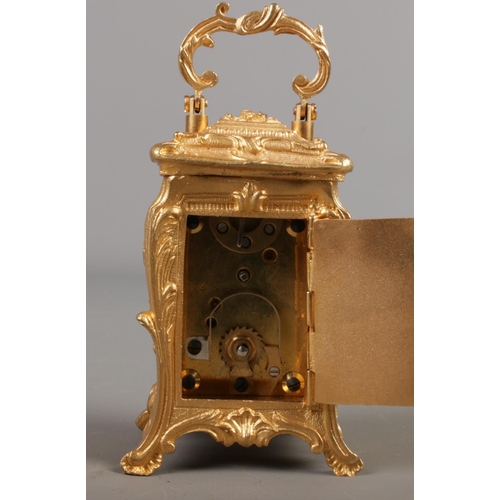 515 - A miniature French gilt carriage clock in the Art Nouveau style. Height with handle 10cm.