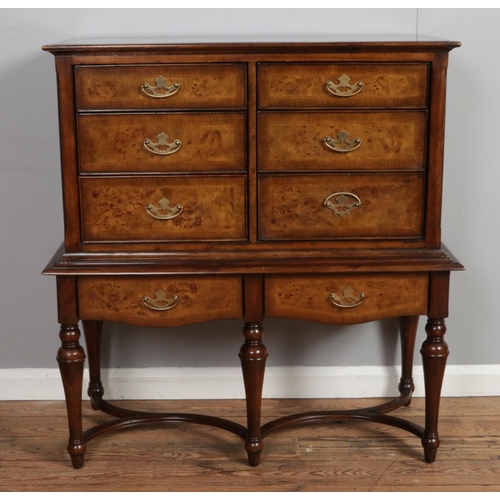 522 - A Willis and Gambier walnut chest on stand.