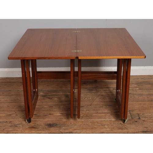 529 - A mid-century McIntosh Triform nest of three tables; the largest having folding and revolving top. R... 