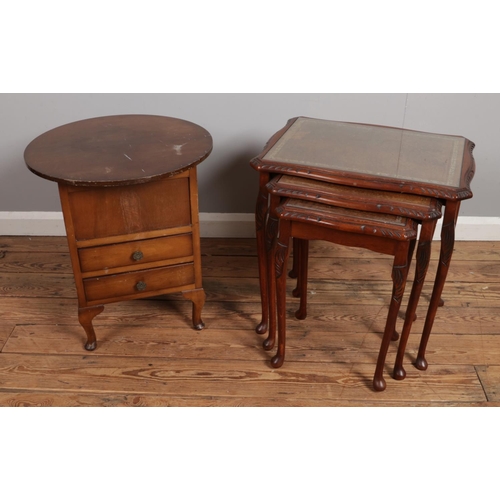 531 - A nest of three mahogany tables with leather inset and glass tops.