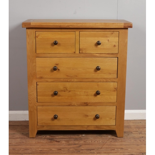 537 - An oak chest of two over three drawers.