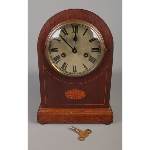 169 - A mahogany German Badische Uhrenfabrik dome top mantel clock featuring banded inlay.