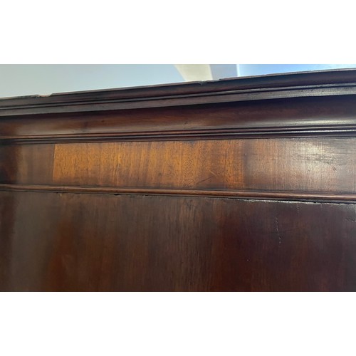 155 - A Georgian mahogany linen press. Having moulded and inlaid doors over drawer base. Height 204cm, Wid... 