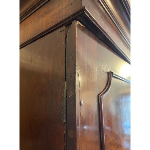 155 - A Georgian mahogany linen press. Having moulded and inlaid doors over drawer base. Height 204cm, Wid... 