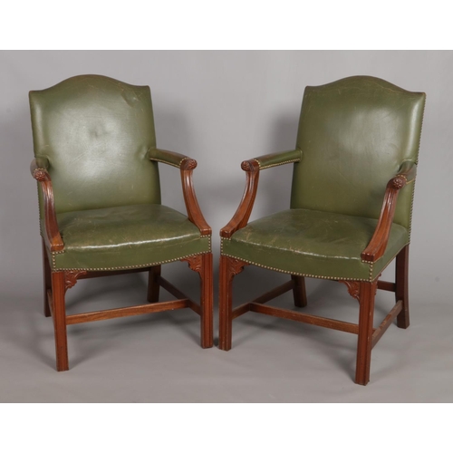 674 - A pair of mahogany Gainsborough elbow chairs. With green leather studded upholstery and carved detai... 