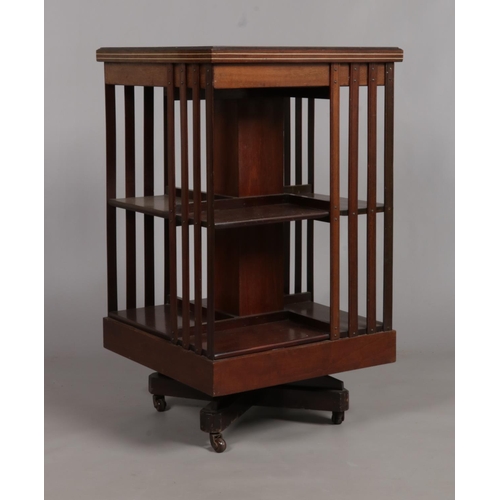 672 - An Edwardian mahogany revolving bookcase. Having marquetry and ivory inlaid decoration. Height 89cm,... 