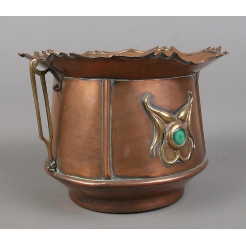 1 - An Art Nouveau twin handled copper jardiniere, with flared rim and central motif to either side feat... 