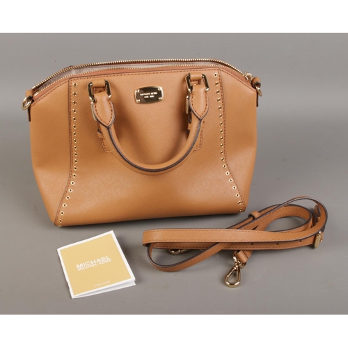 15 - A brown Micheal Kors bag with strap.