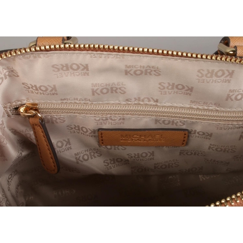 15 - A brown Micheal Kors bag with strap.