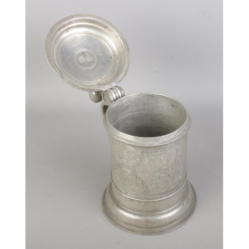 3 - An 18th century Bohemian pewter quart tankard. Decorated with floral engraving, ball finial thumbpie... 