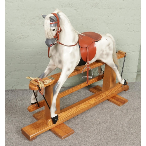 377 - A large painted fibreglass rocking horse by Haddon Rockers. With horse hair mane and tail, leather b... 