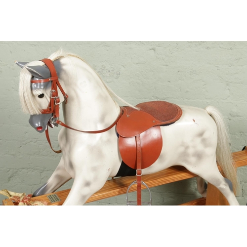 377 - A large painted fibreglass rocking horse by Haddon Rockers. With horse hair mane and tail, leather b... 