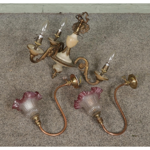 394 - A pair of copper and brass sconces with frilled cranberry tip glass shade stamped S.M.Gas Co with a ... 